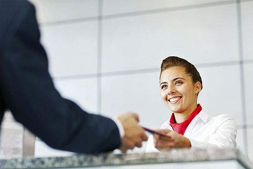 Service employee receives documents from participant at the service counter